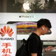 A man passes by an electronics store in Beijing, May 2019.